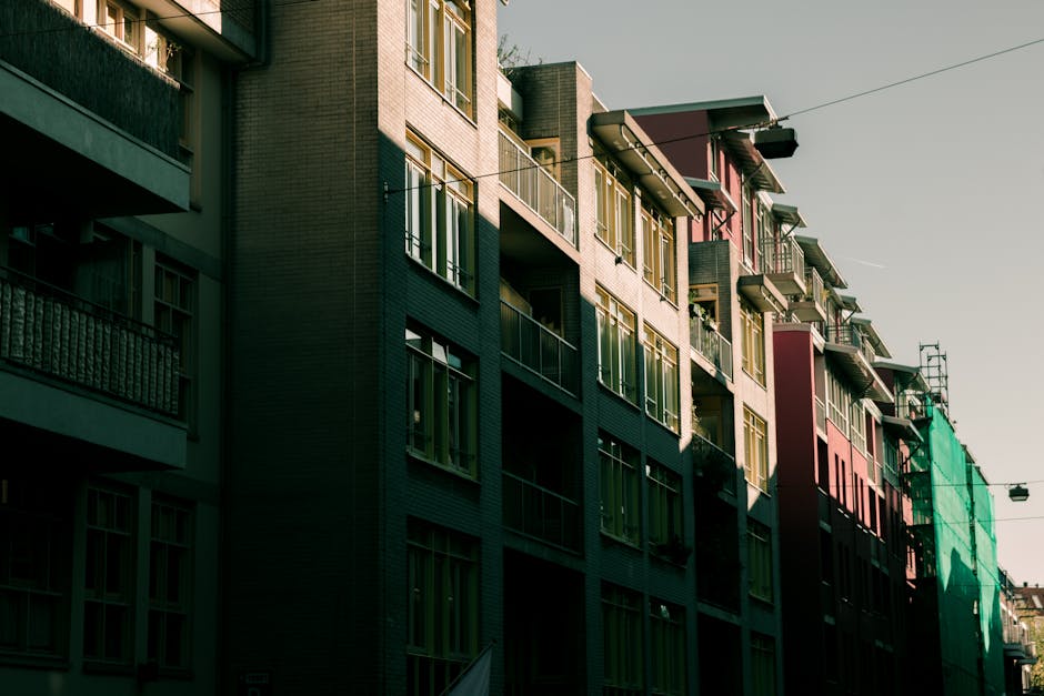 Modern apartment buildings in Amsterdam with distinct urban architecture and muted colors.