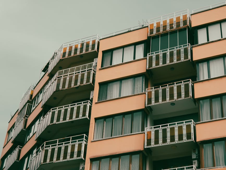 A contemporary apartment building with balconies in an urban setting.